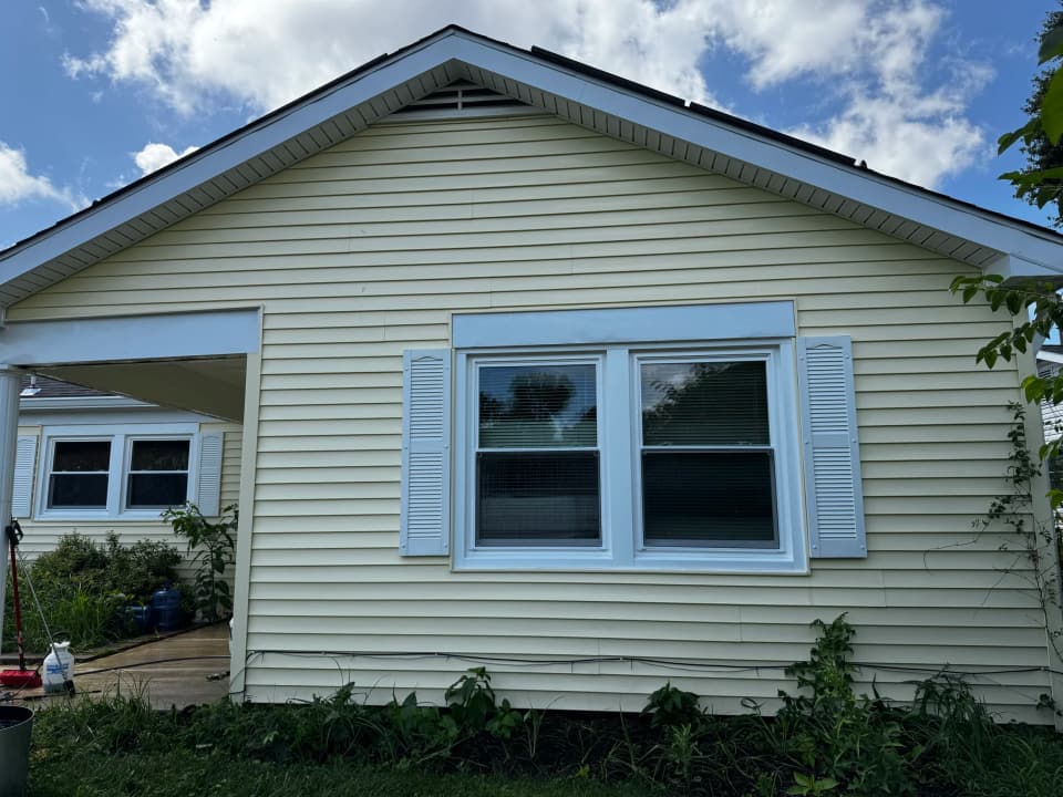 After: the same siding clean and evenly colored after a soft wash